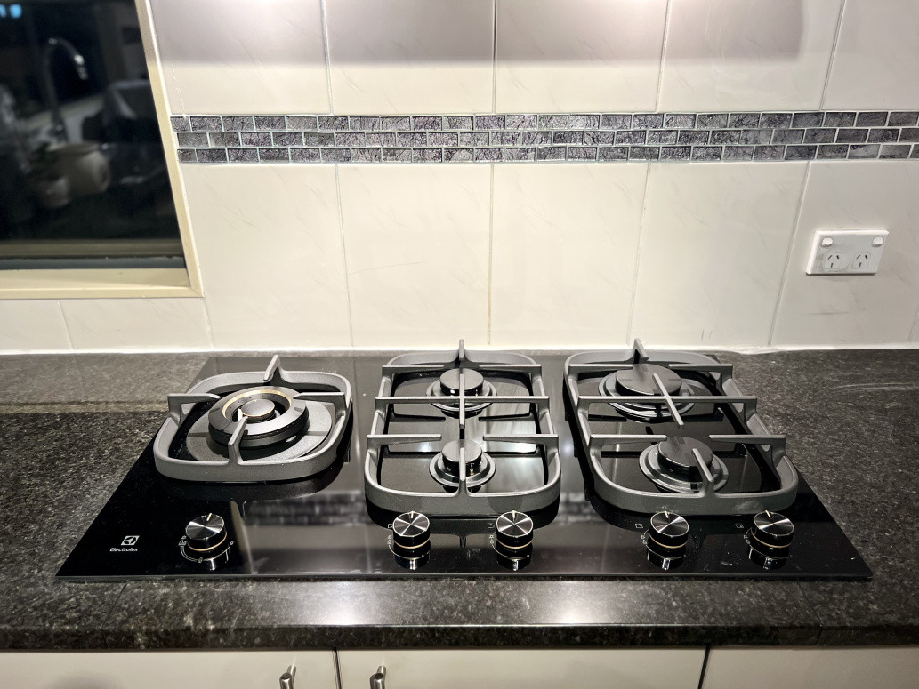 Installation of a new black glass gas hob