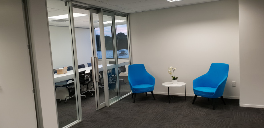 Meeting room created off reception area, built from aluminium extrusion on site including fabrication and hanging of glazed aluminium sliding door and full height glass