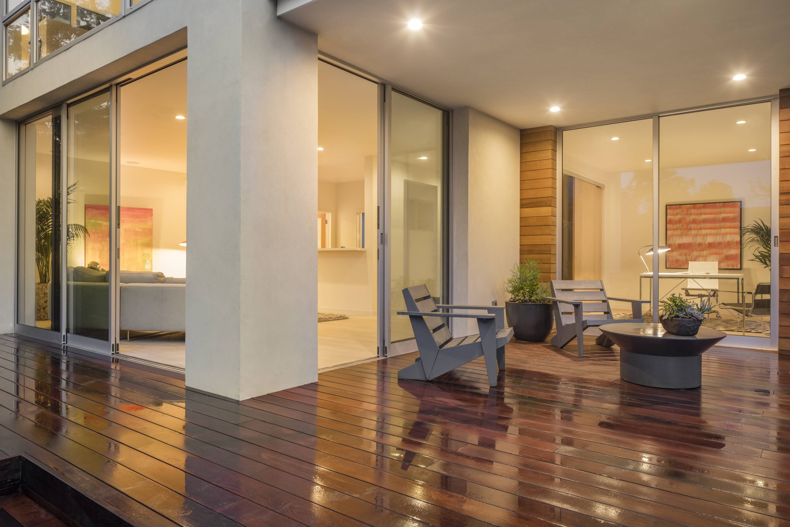 shutterstock_535657708 Modern Kiwi home with seamless indoor-outdoor flow onto a timber deck.