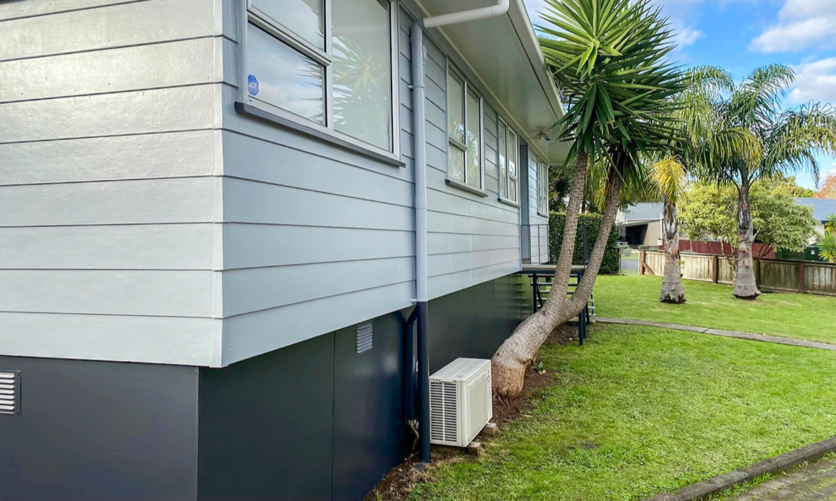 Modern Kiwi home with seamless indoor-outdoor flow onto a timber deck.