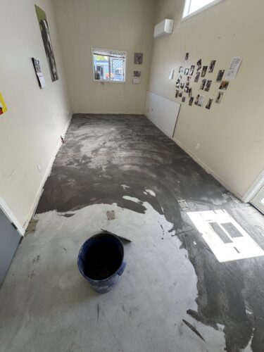 feather finish compound trowelled across the concrete office floor