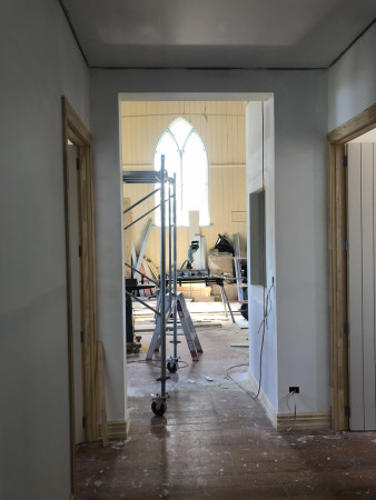 A in progress look through from the hallway into the open plan kitchen, dining and lounge area