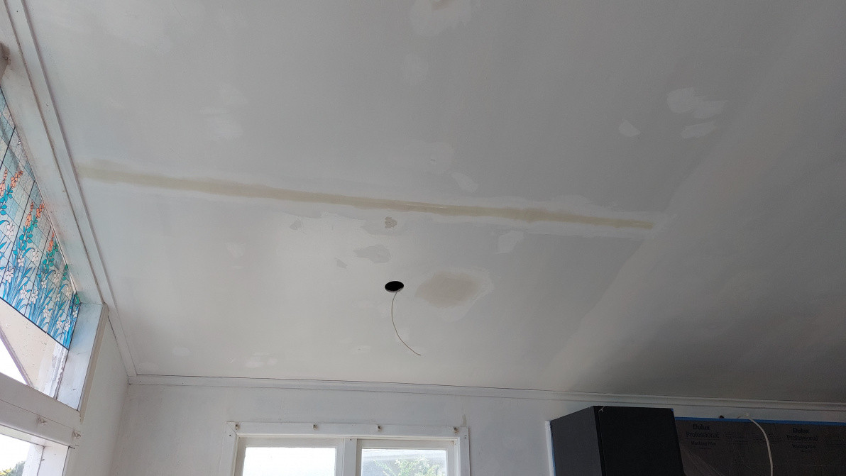 Taping and mudding a ceiling crack and piece of plasterboard repaired
