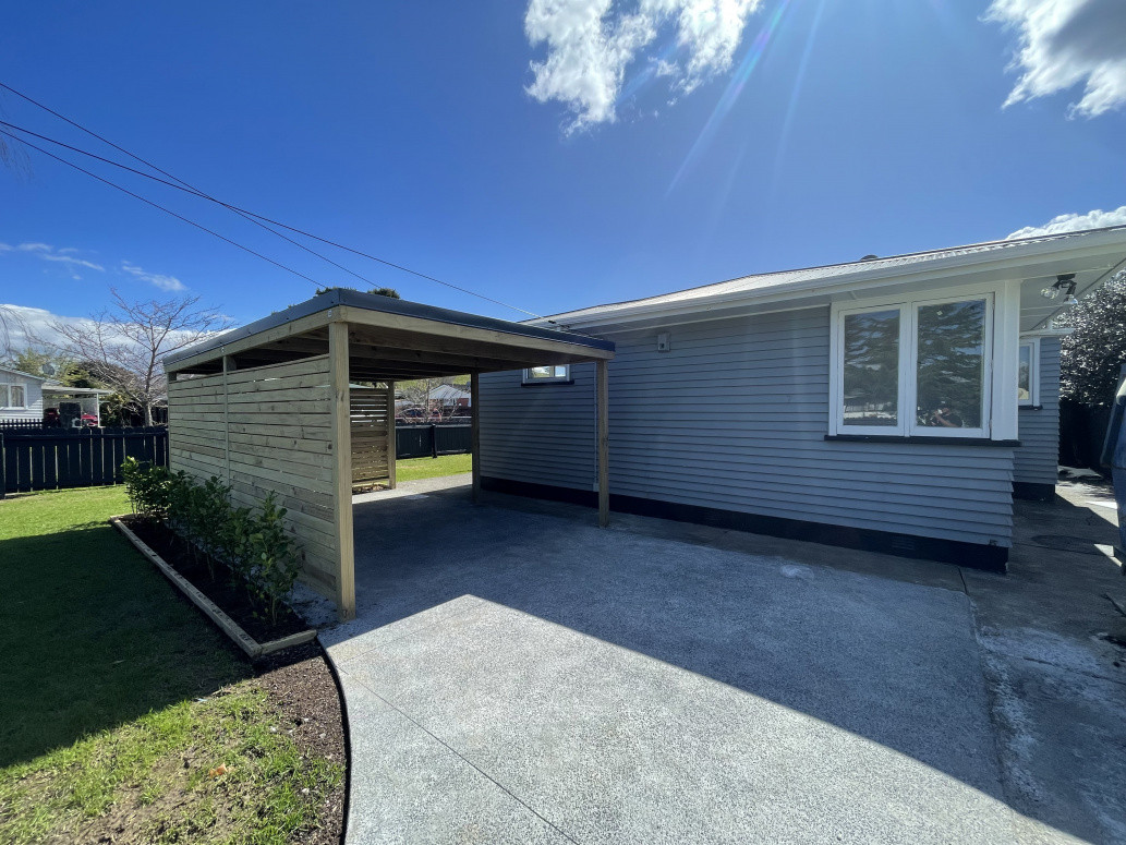 New 5.4x3.5m carport. New exposed concrete. Privacy screening with garden edging finished of with hedging.