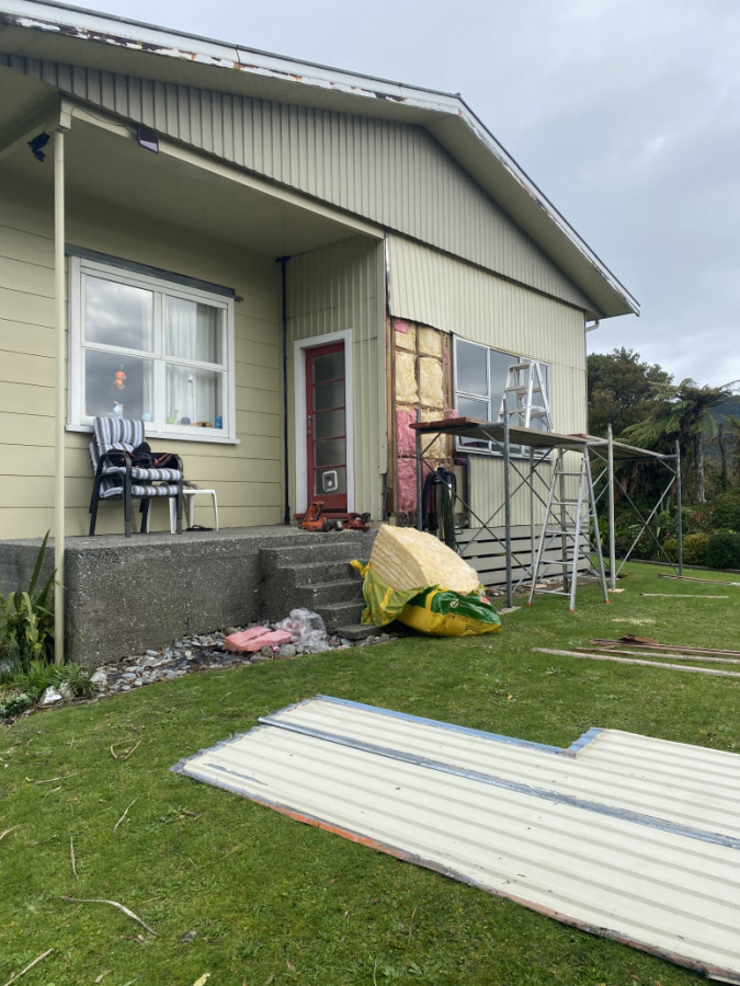 Stripping iron off wall to wrap it and install new window and new Hardie cladding