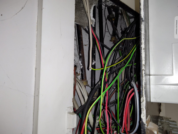 Asbestos containing insulation board in behind the Fuse Board