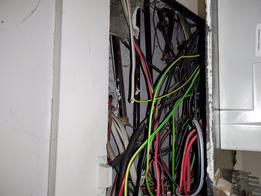 Asbestos containing insulation board in behind the Fuse Board