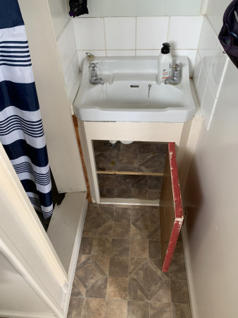 Enclosed old shower with vanity