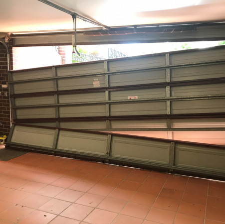 Snapped torsion cable led to the garage door collapsing and damaging panels. Repaired the dents in the panels, replaced broken hinges and cables, retighten the springs and general maintenance for the door and automatic opener.