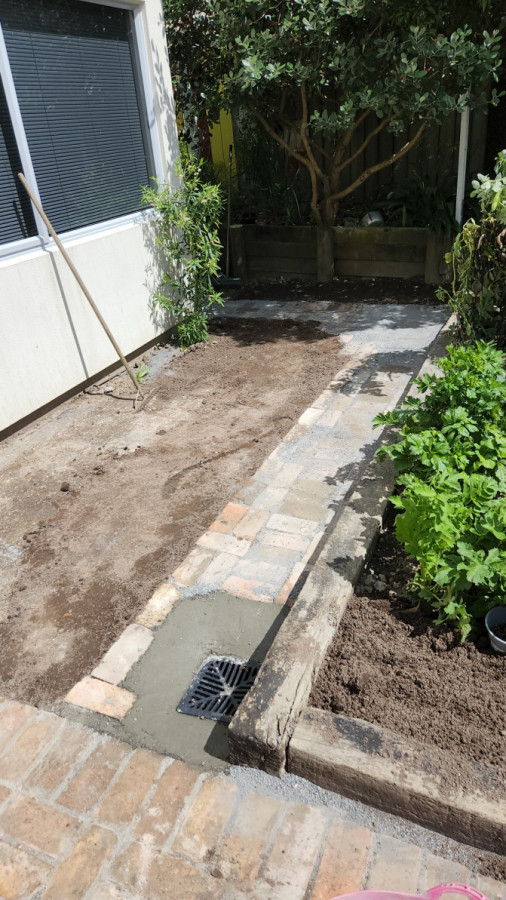 Using recycled bricks from a chimney to create patio & walkway