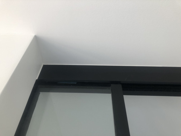 Glass sliding door to ceiling detail