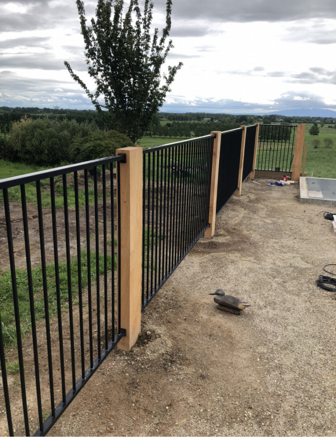 New aluminum fence with macrocarpa posts