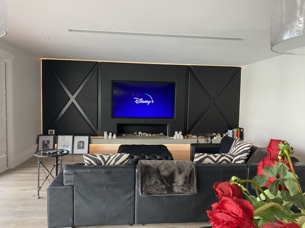 85" TV installed onto full motion bracket and controlled with Control 4 universal remote