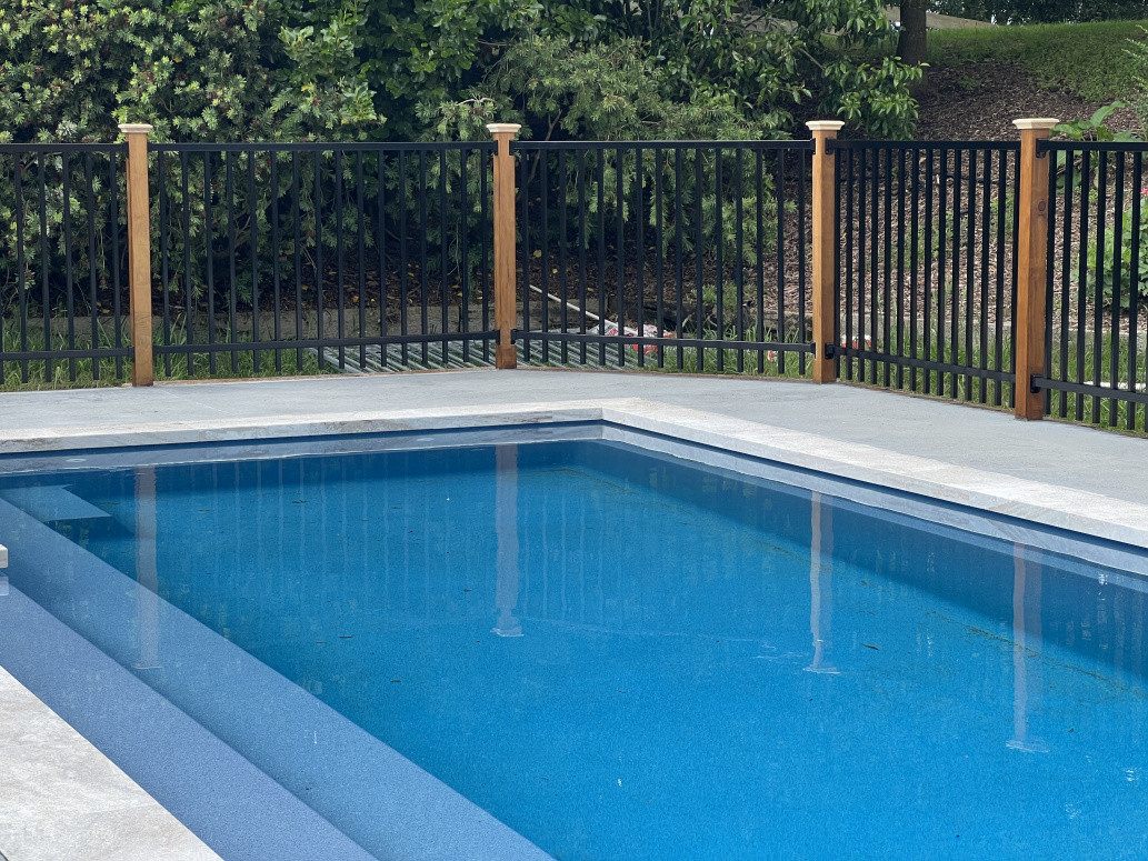 Swimming pool surround ½ Black with Black Mercury Fencing with Prolam posts with Ox Builders