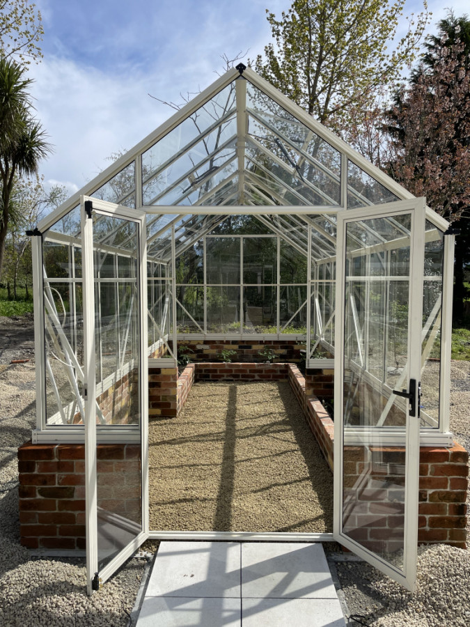 Glasshouse with Recycled red brick on a solid foundation