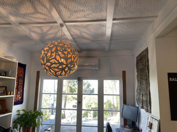 David Trubridge Coral Light fitting illuminating dining room.