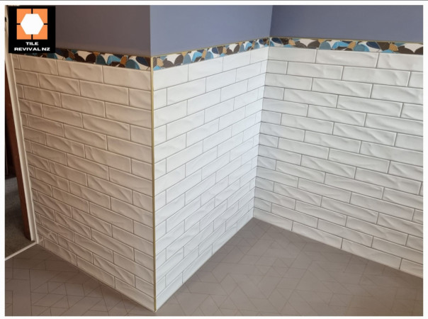 Bathroom Walls with feature tile, and brass trim.