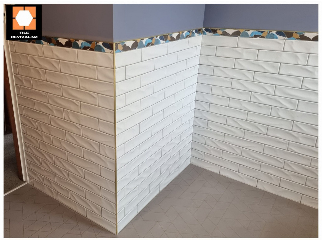Bathroom Walls with feature tile, and brass trim.