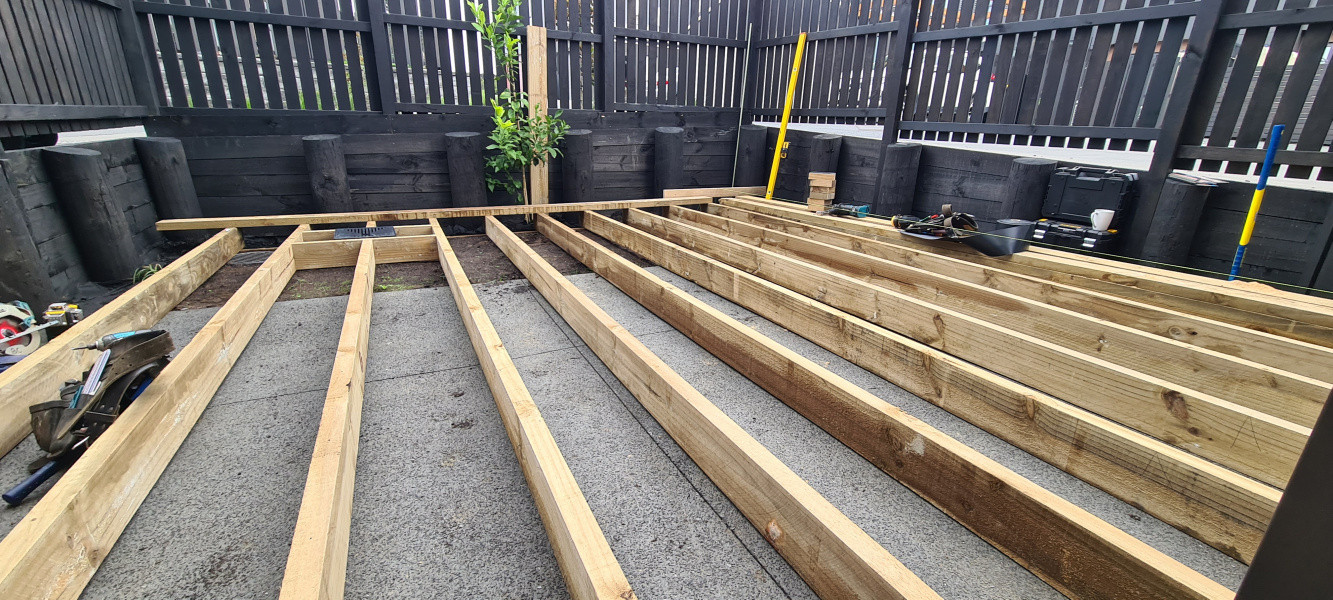 Framing out staging. Packing joists level off existing concrete slab