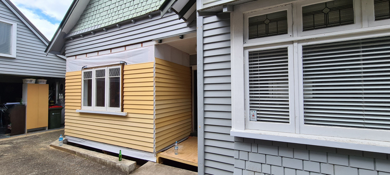 Cladding up to head flashing height