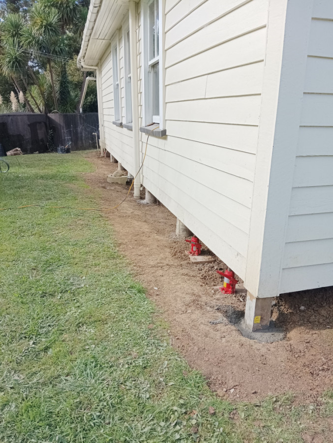 New anchor pile with existing concrete piles reset.