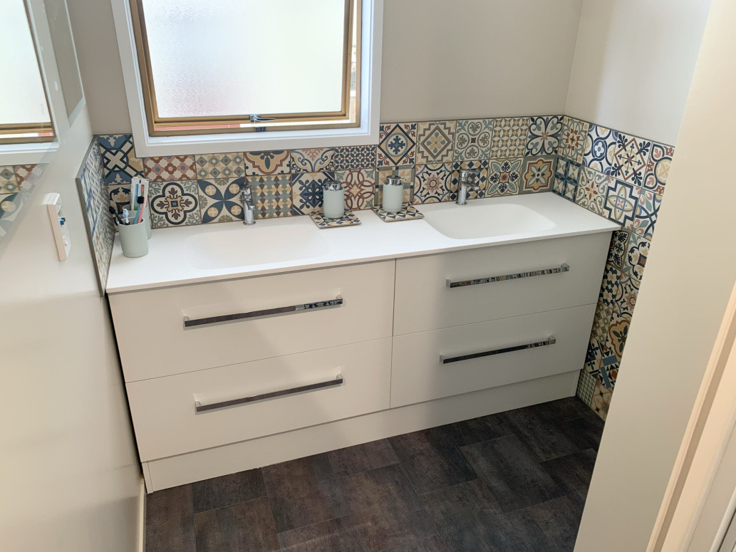 Tiles over and around vanity