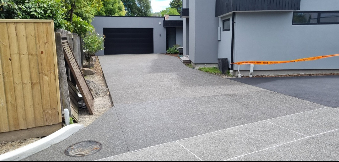 Exposed half shot black driveway, darker area is sealed lighter area isnt