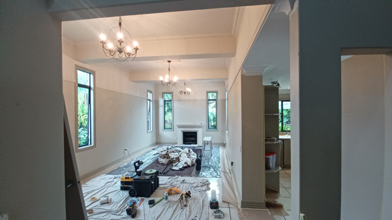 Interior house repaint. Protection from paint drips and spills is just as vital to prepping ceiling, walls and woodwork. Leaving a professional finish