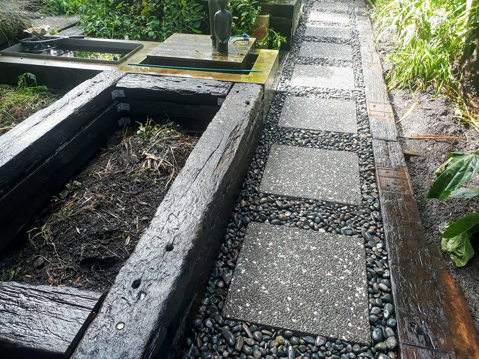 Sleepers added to create amazing garden beds, pebbles and steppingstones to create a low maintenance pathway.