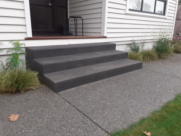 black oxside steps with exposed aggerate paths and landscaping