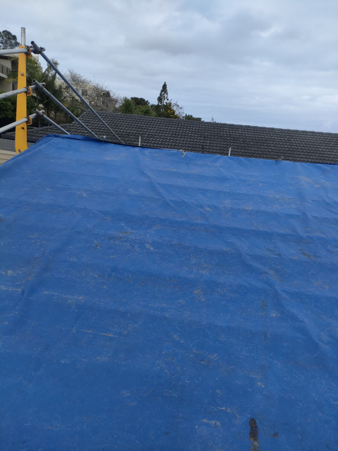 Tarps used to cover roof.