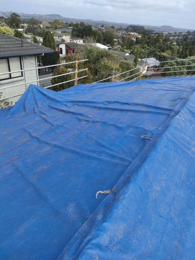 Tarps used to cover roof after removal.