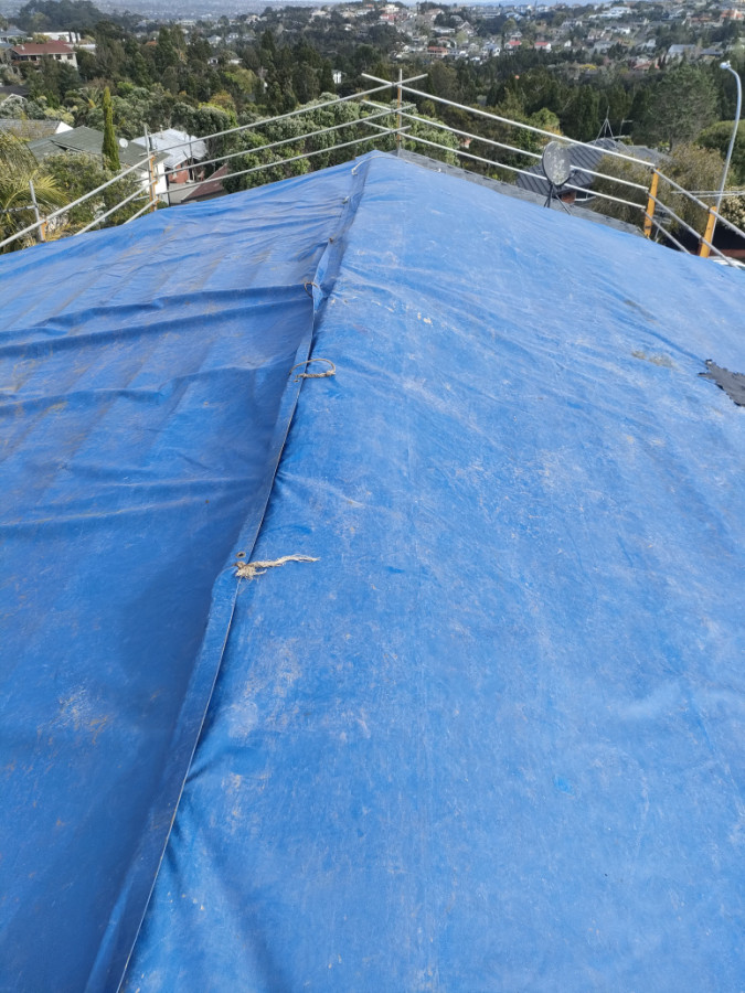 Tarps used to cover after class b asbestos roof removed.