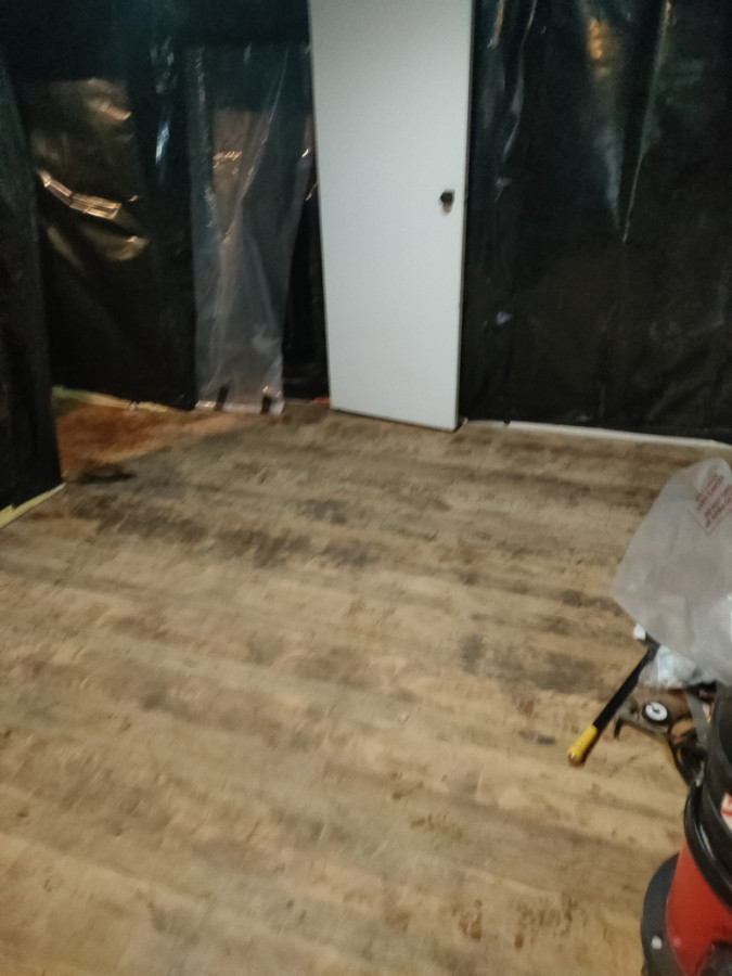 Removal of asbestos floor tiles.