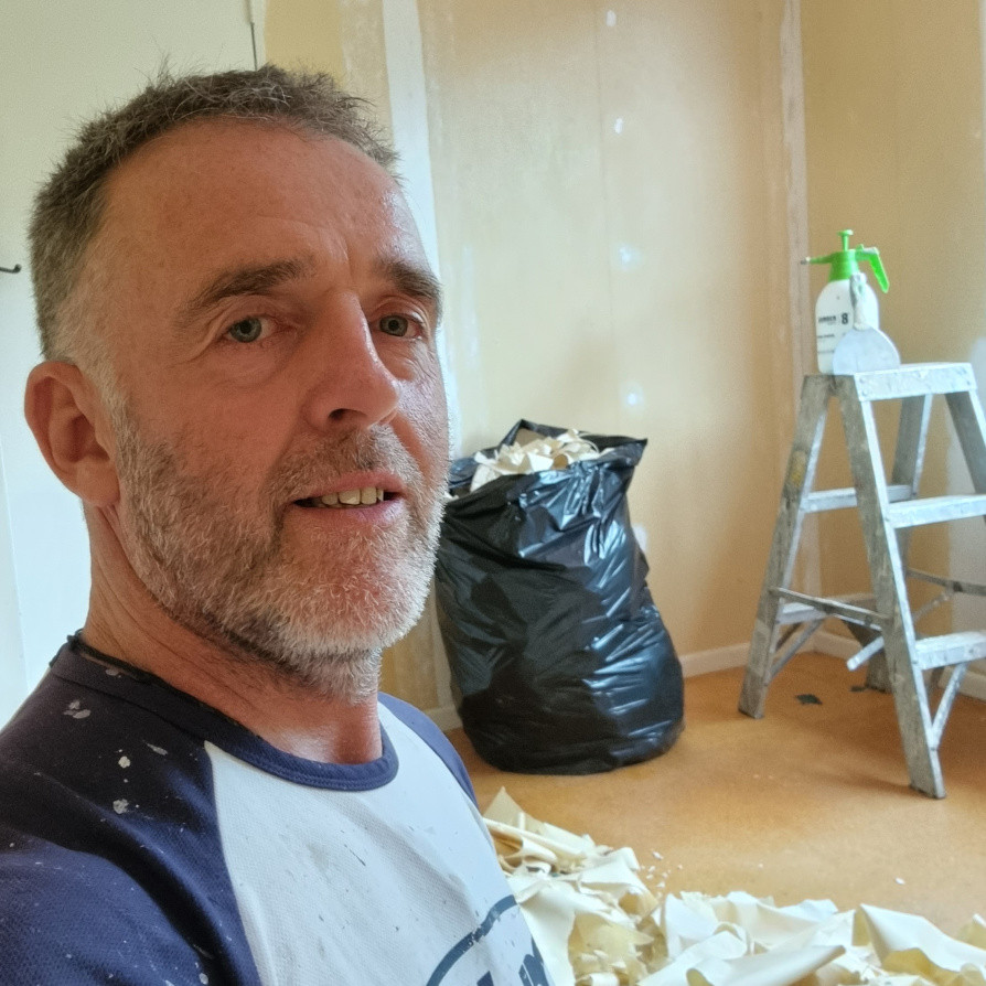 Removing wallpaper, skimming plastering walls for a paint quality finish.