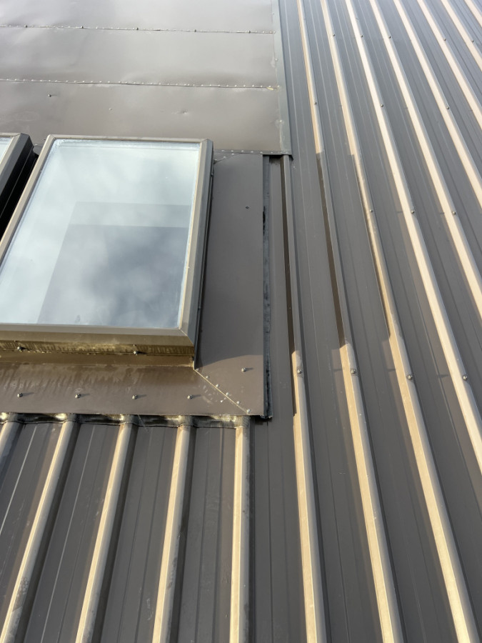 Previous contractor installed skylight flashings short