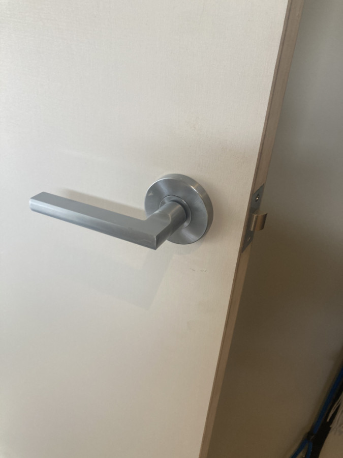 New door hardware added to a new door leaf