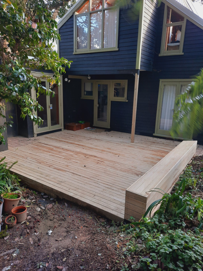 New deck, lifted door, side bench, and area for wood oven