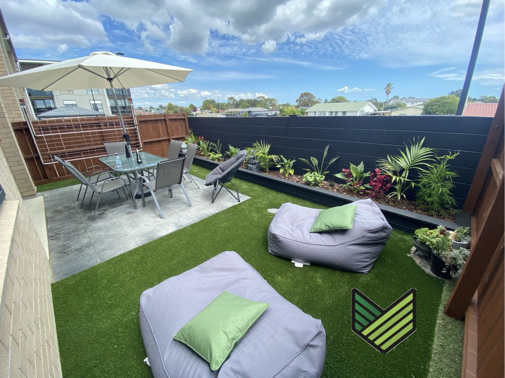 Paving, Artificial turf, Raised garden bed and planting.