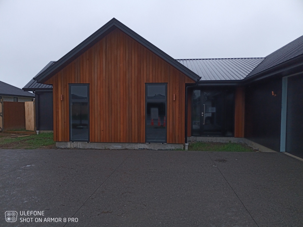 Western red Ceda shiplap weatherboard installed by us also installed  the exposed aggregate driveway.