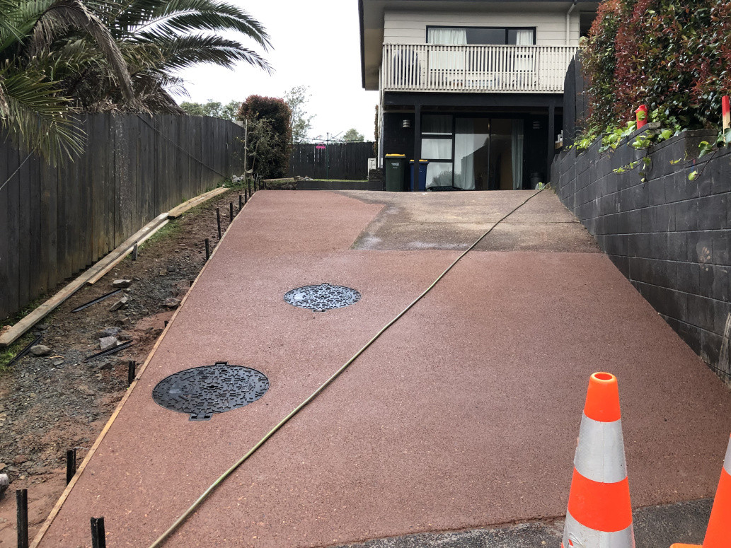 Exposed red chip concrete driveway