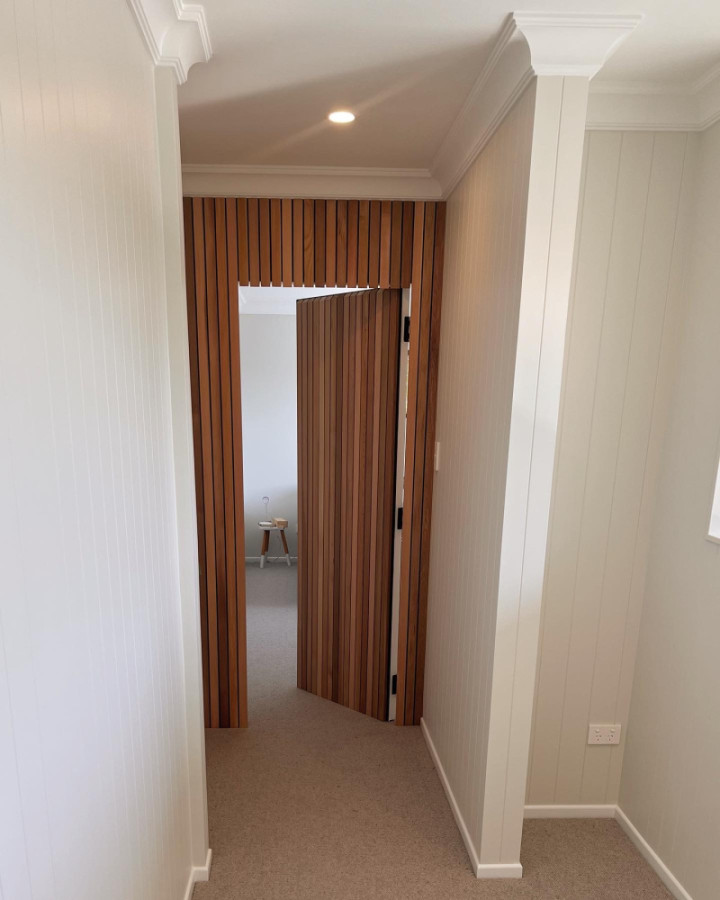 Cedar feature wall including a hidden doorway leading into the youngest child’s bedroom.