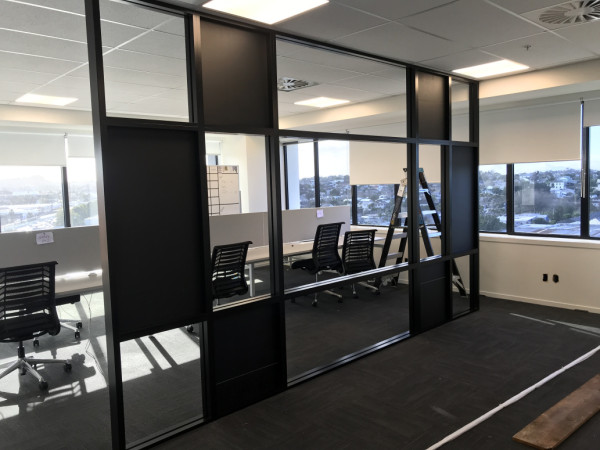 Glazed/pinboard feature dividing wall in black aluminium