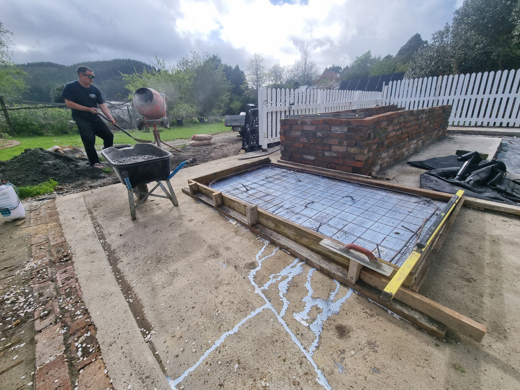 Moody weather . Finishing large block garden bed , and placing a level pad for 1.5ton bio-digestor.