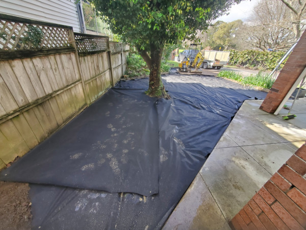 Prep ground and lay geotextile cloth to reduce base shrinkage.