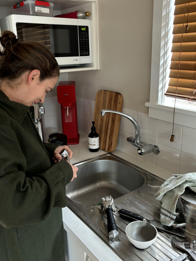 Emma fixing a leaking tap