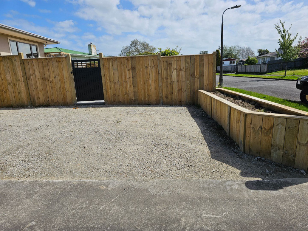 Timber paling fence with built in garden bed