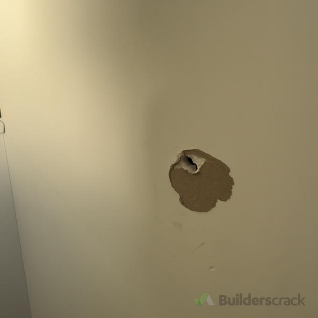 Small hole in bathroom wall ( 920488) Builderscrack