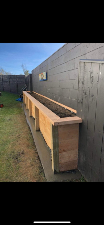 Planter box with concrete mowing strip