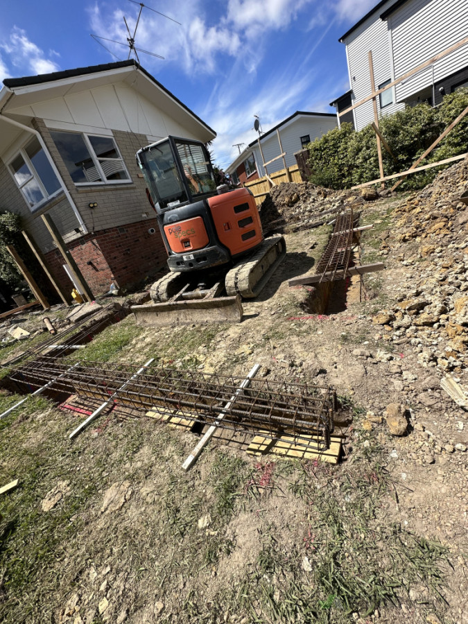Ground beams for house extension , trench holes and poles set with reinforced footings